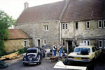 Courtyard; putting in a stairs to new attic room 1990, the Coffeys and old Merc.